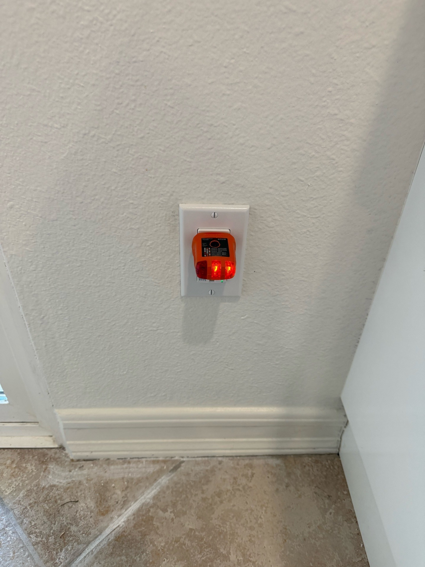New kitchen GFCI outlet with a plug-in tester showing power