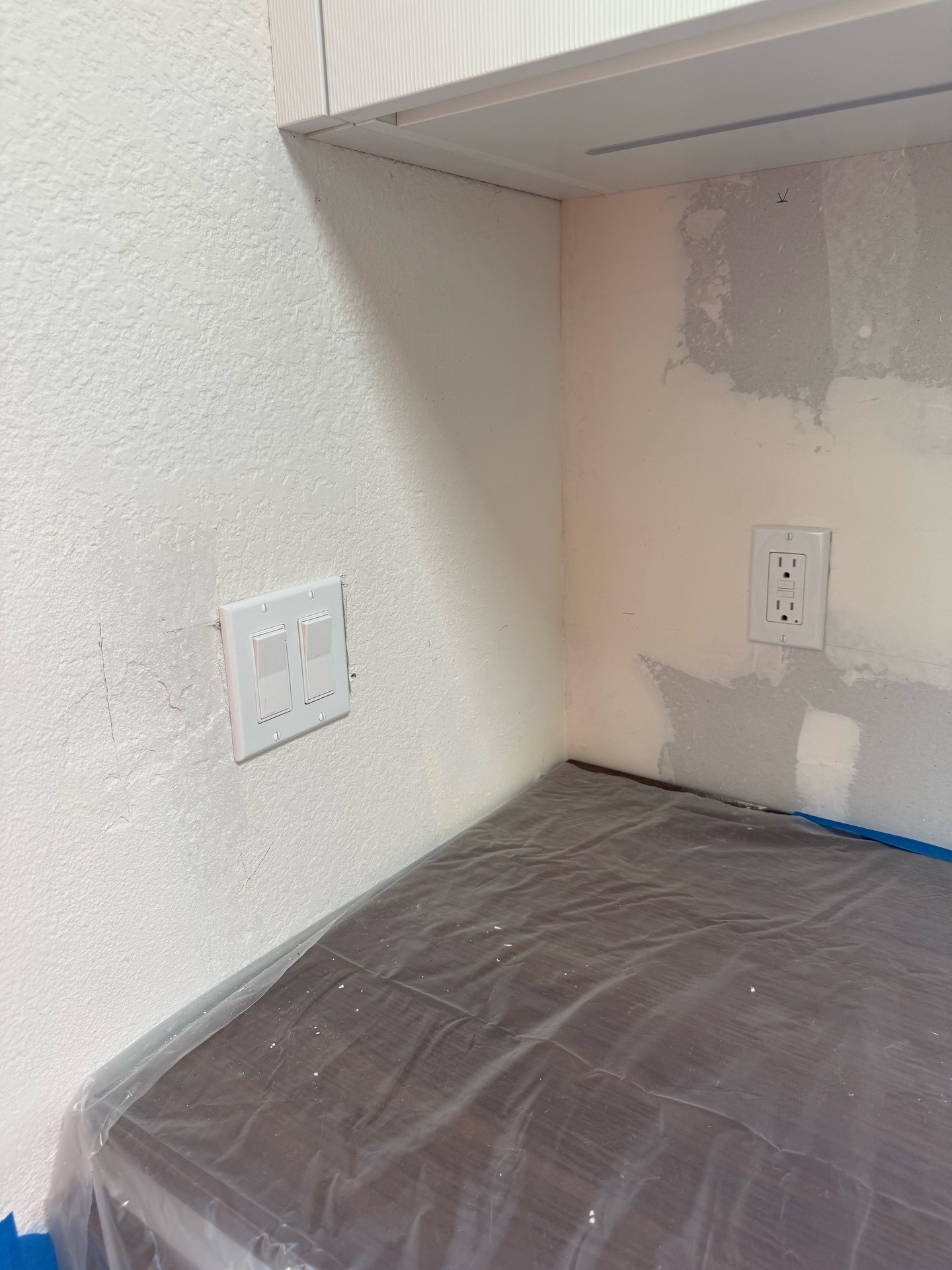 Installed switches and receptacle during kitchen electrical trim-out
