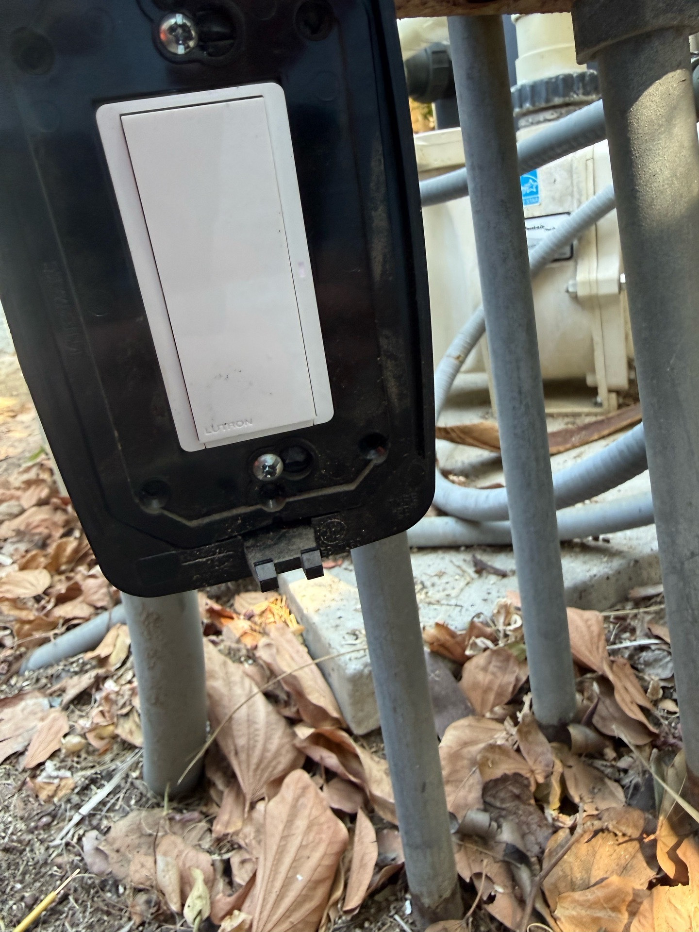 Installed white Lutron RF switch in an outdoor equipment box