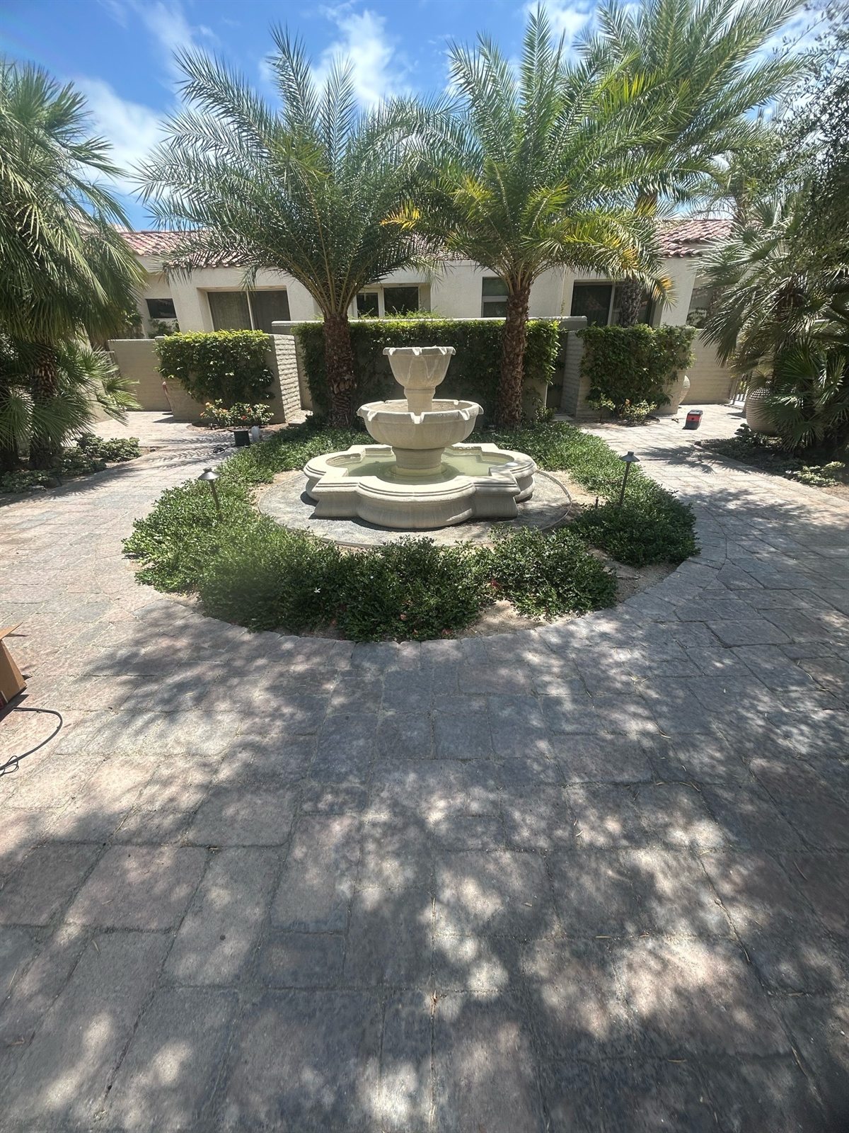 Landscaped HOA common area with pathway and courtyard lighting