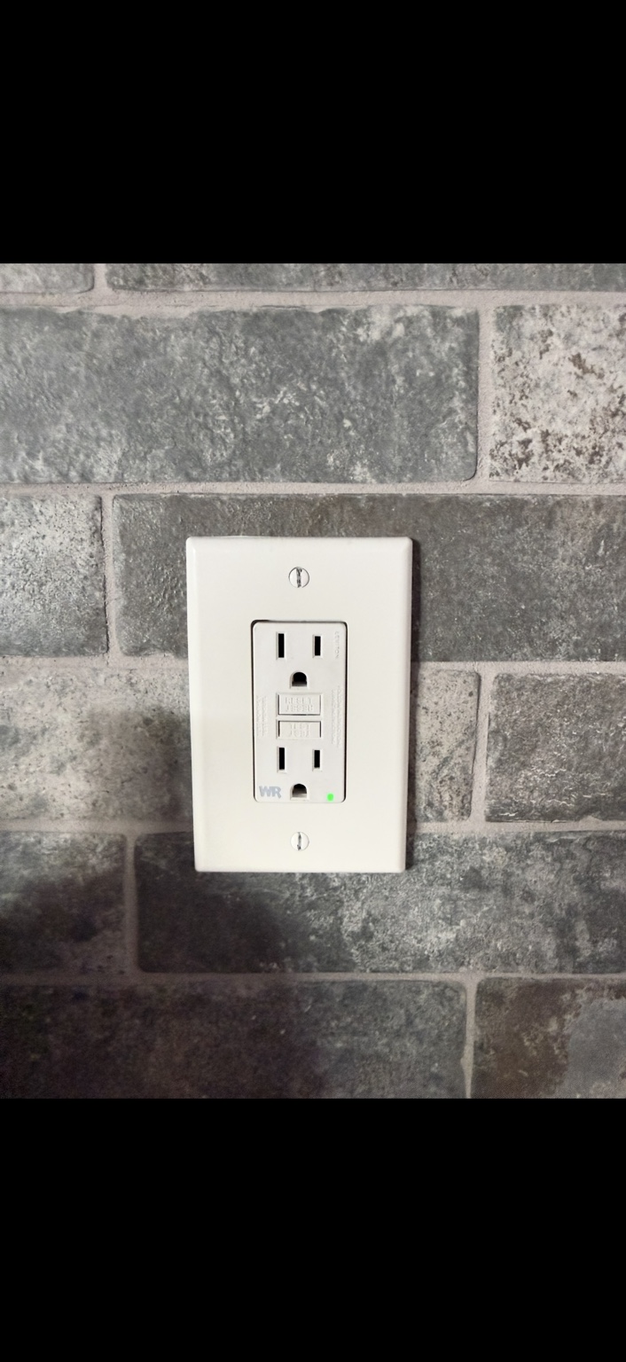 Installed indoor GFCI receptacle with test and reset controls