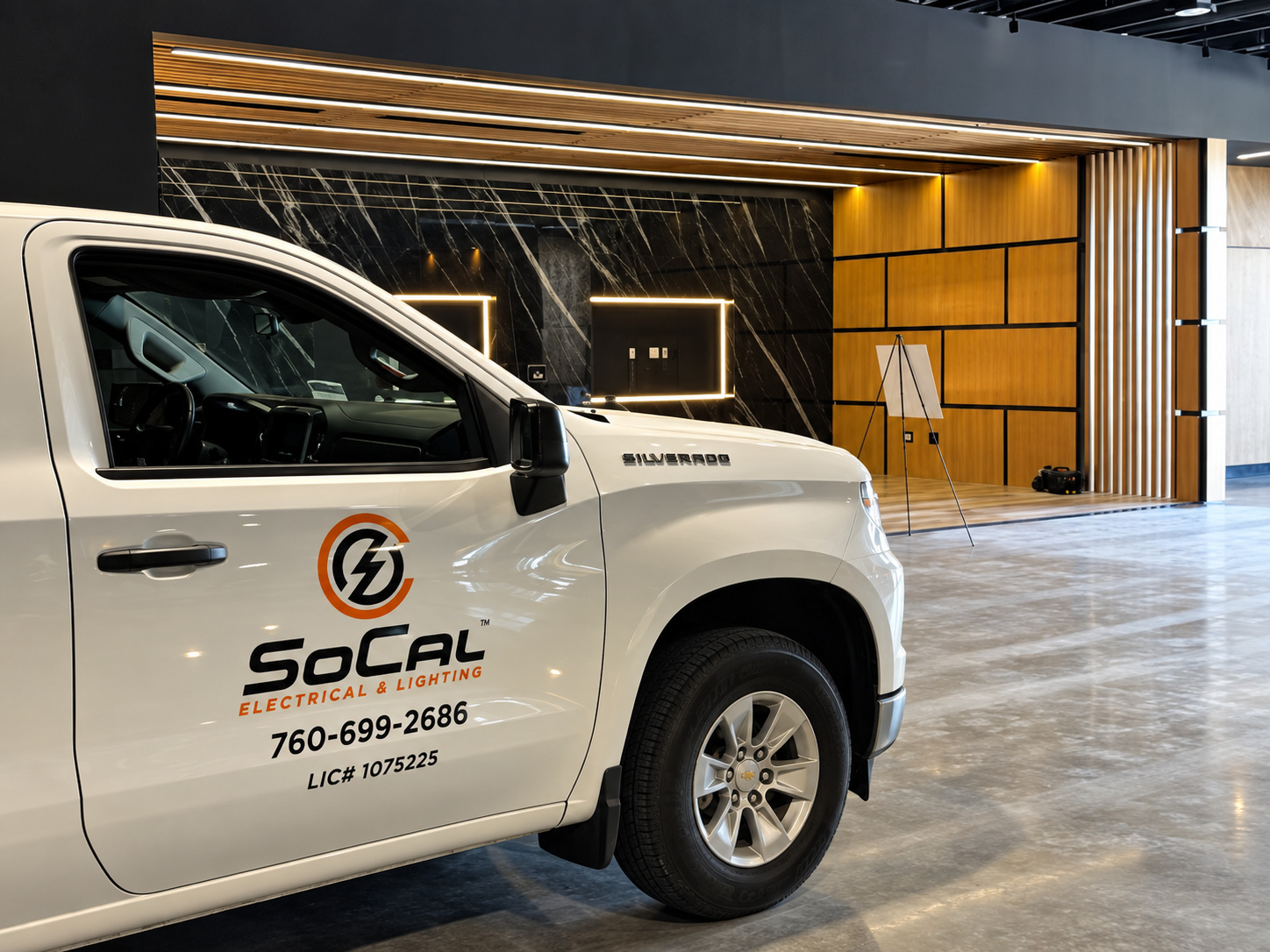SoCal Electrical & Lighting service truck inside a commercial space with architectural lighting.